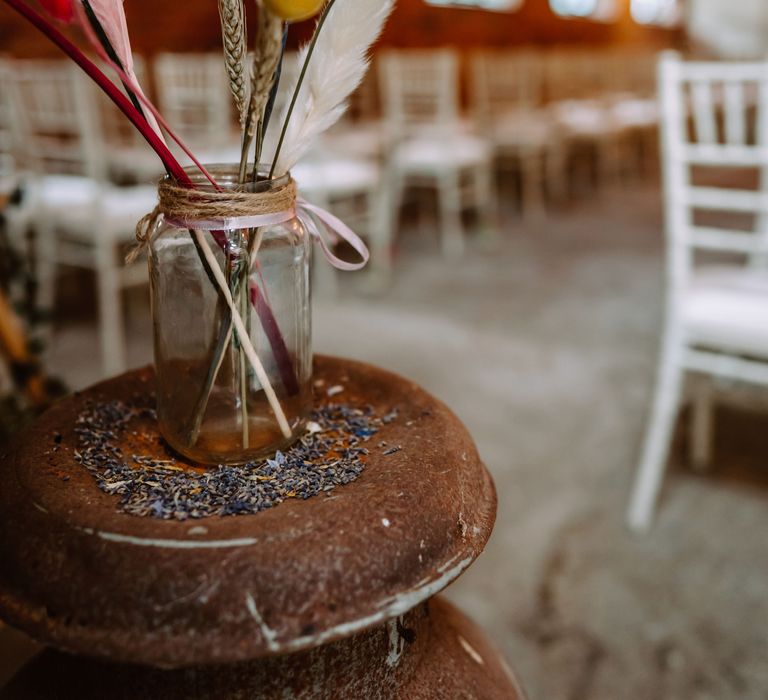 Dried florals and pampas grass in mason jar tied with brown string