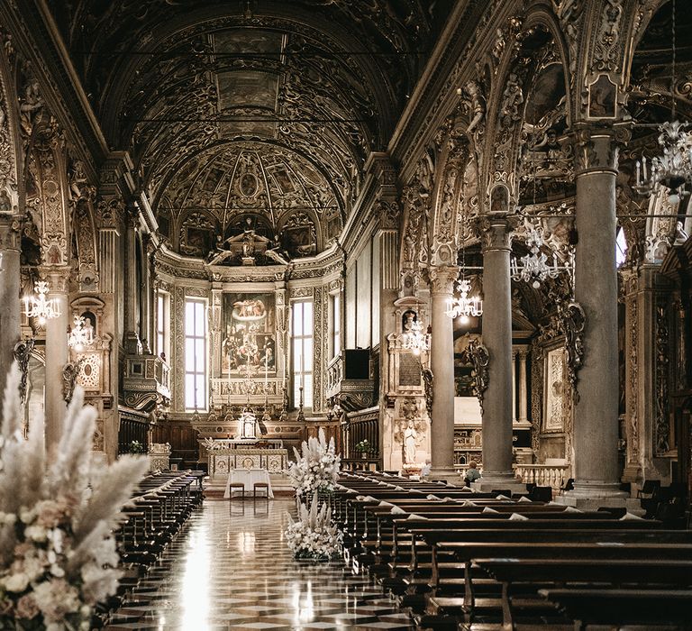 Beautiful gilded church in Italy complete with pampas grass floral decorations throughout 