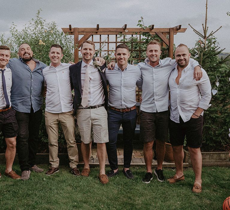 Groom and groomsmen in relaxed shorts and chinos wedding outfits