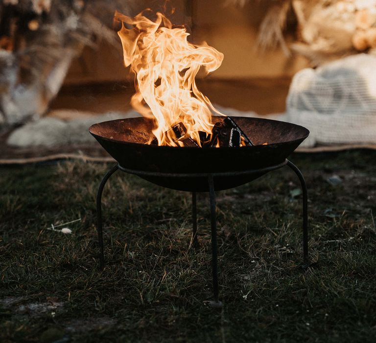 Fire pit at boho bell tent wedding proposal 