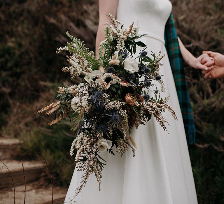 neutral wedding bouquet with anemones, ranunculus, thistles and wildflowers