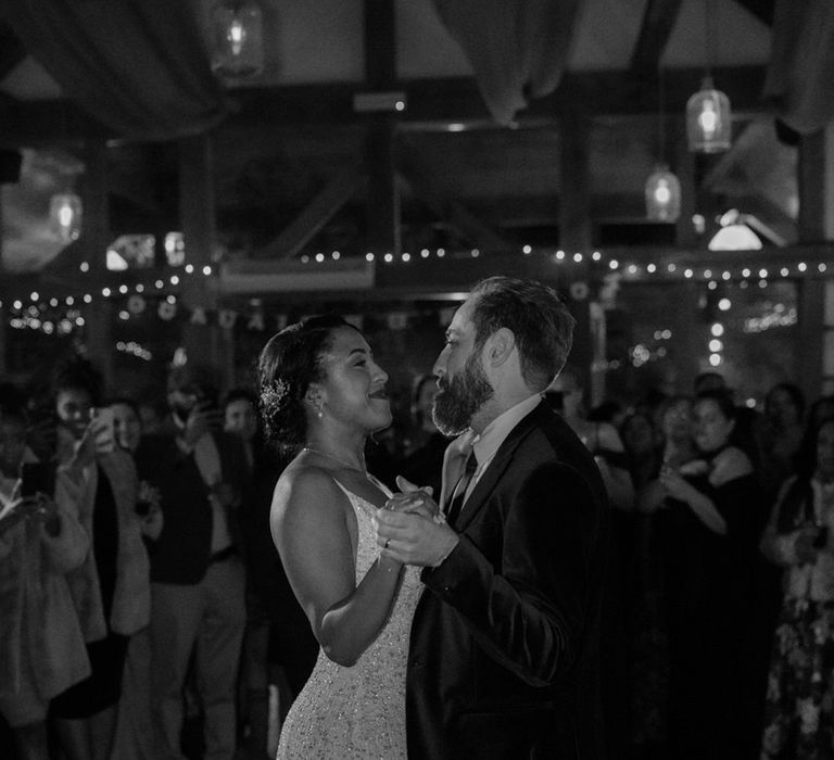 Black & white image of bride and groom dancing during wedding reception