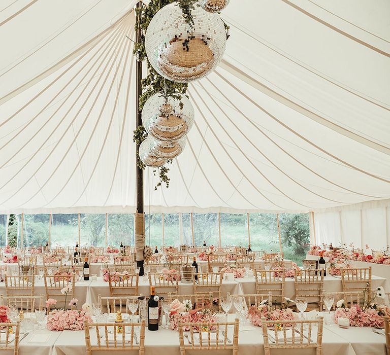 Summer marquee wedding with disco balls and pink accents