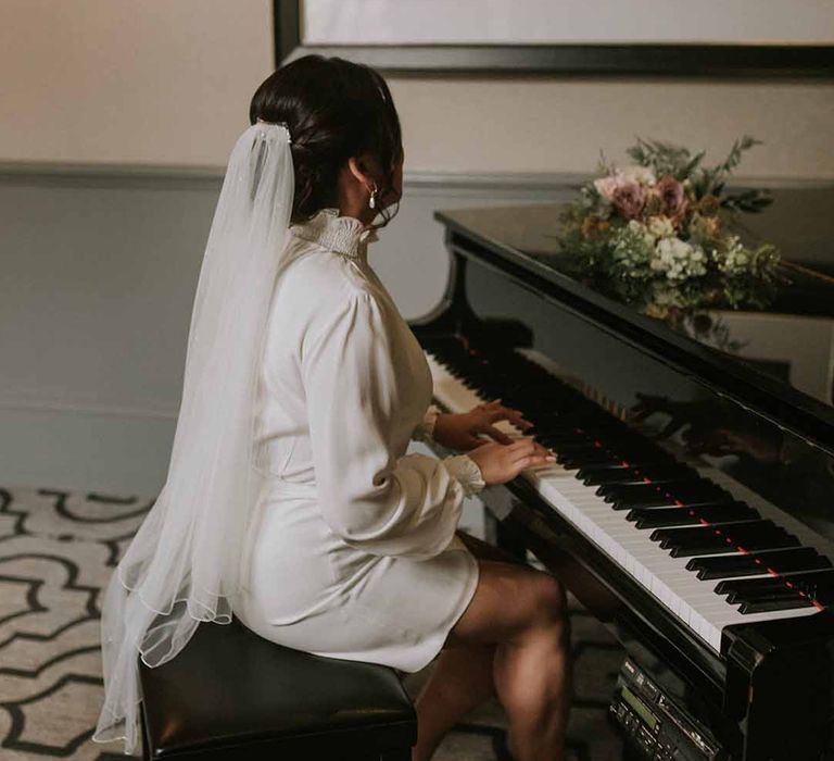 Bride in Vanessa Cocchiaro Paris wedding dress with long, elegant white veil 