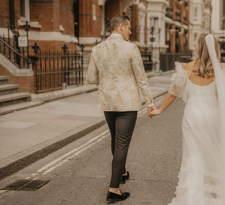 Bride and groom walk around London on their wedding day 