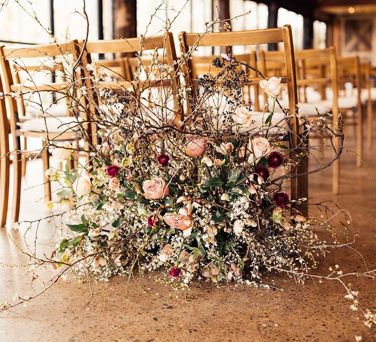 Pink and red rose wedding flowers with twigs for spring wedding at Dewsall Court 