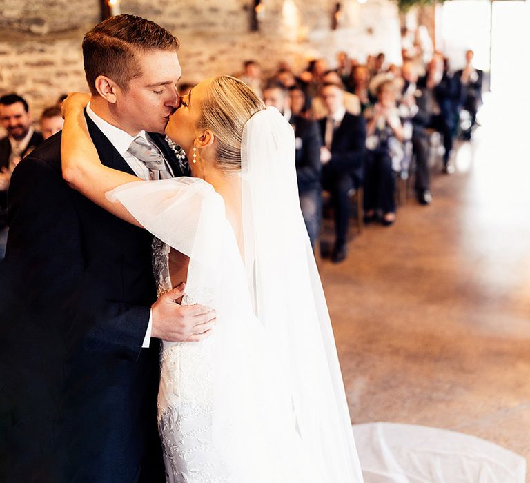 Bride and groom share their first kiss as a married couple