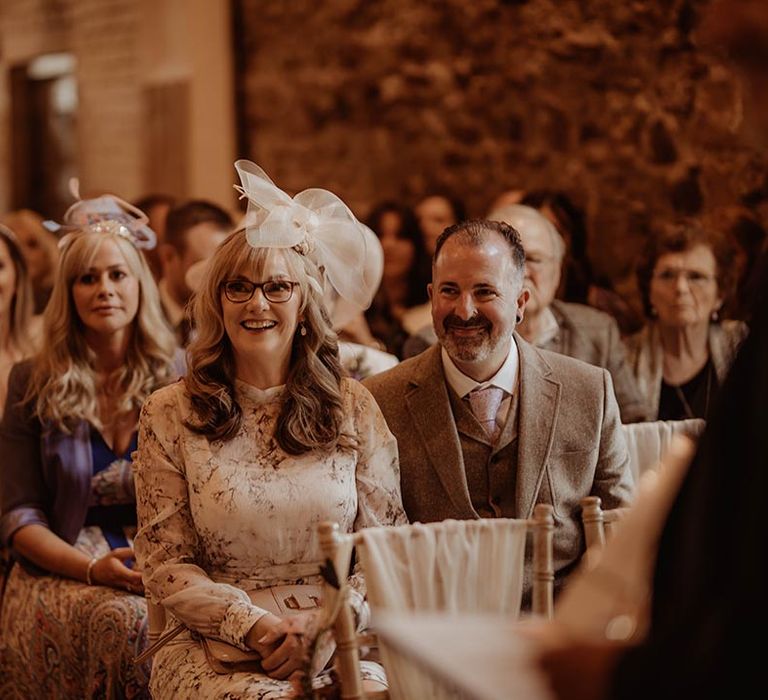 Wedding guests watch the wedding ceremony excitedly 