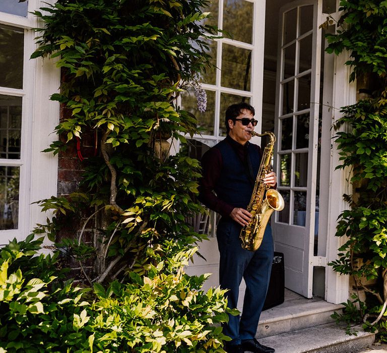 Wedding entertainer plays the saxophone for traditional wedding at Goldney Hall