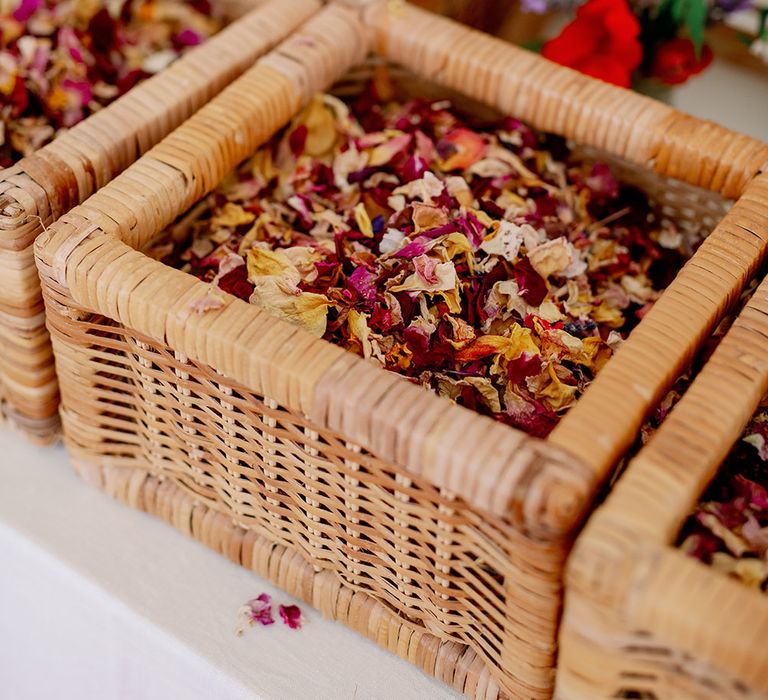 Colourful dried petal confetti in wicker basket 