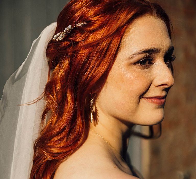 Bride with red hair and gold hair accessory for her wedding day 