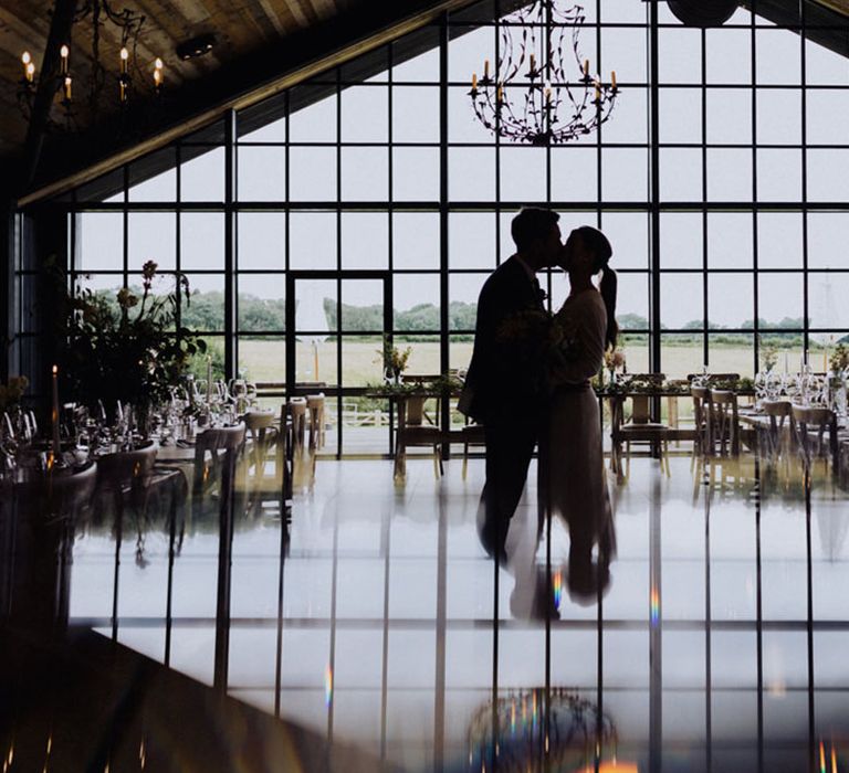 Bride and groom stand in The Barn at Botley Hill wedding venue 