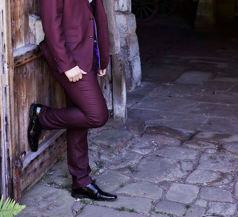 Groom in a two-piece burgundy wedding suit 