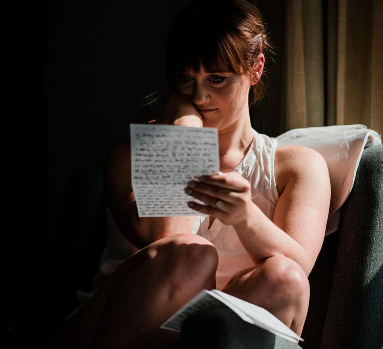 Bride reads letter on the morning of her wedding day