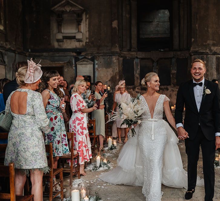 Bride walks down the aisle with her groom after Asylum wedding in London 