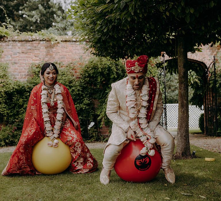 Bride & groom play lawn games outdoors at Braxted Park Estate before wedding reception