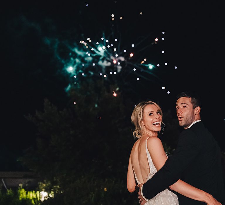 Bride & groom watch reception fireworks outdoors at Castello di Petrata Umbria Villa 