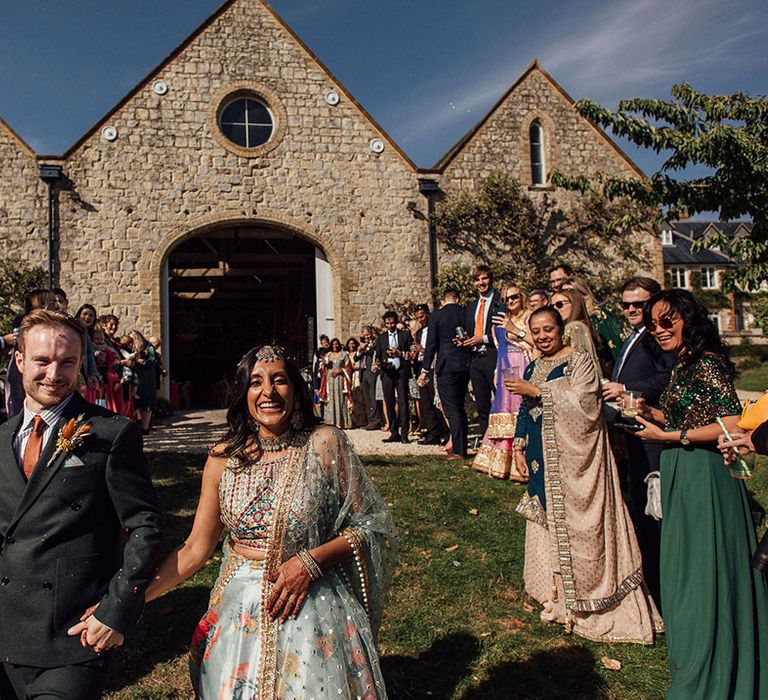 Bride & groom leave Longbourn Estate Barn during confetti exit 