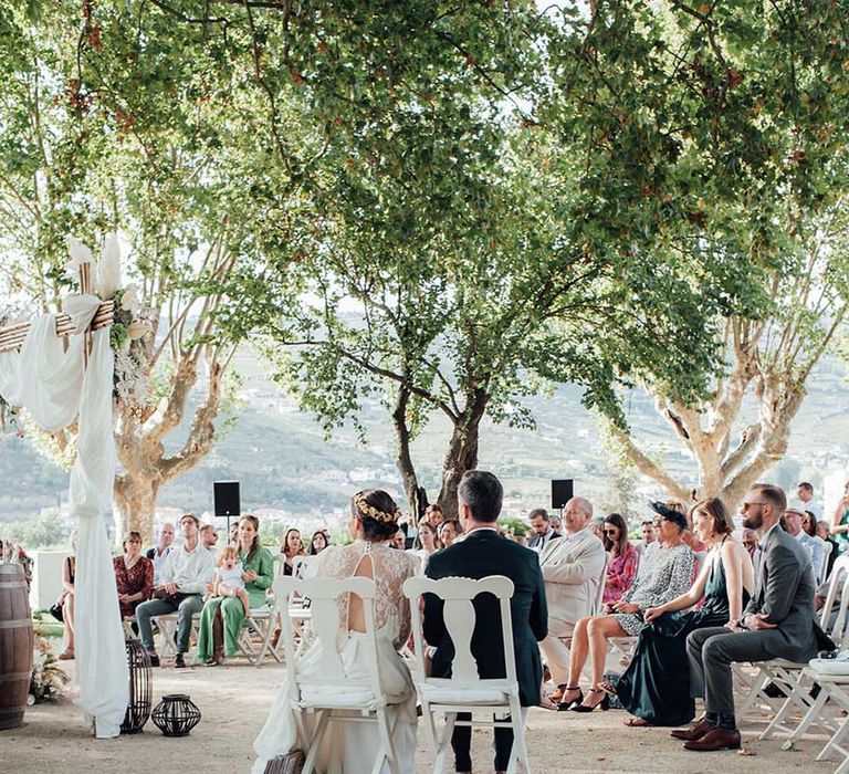 Portugal outdoor wedding ceremony with boho wedding decor and bridal gown 