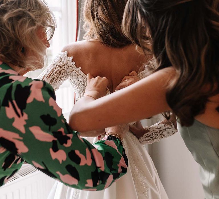 The wedding party helps the bride gets ready for the wedding day 