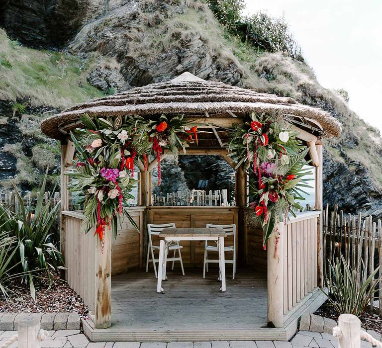 Wedding pagoda at Tunnels Beaches with colourful tropical African flower arrangements 