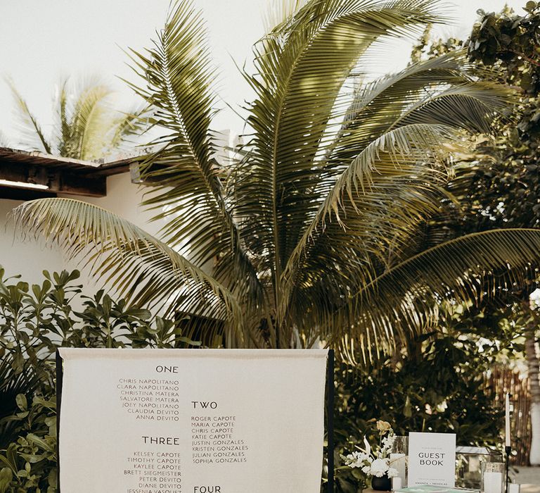 fabric table plan wedding sign and guest book table wedding decorations at Mexico beach wedding 