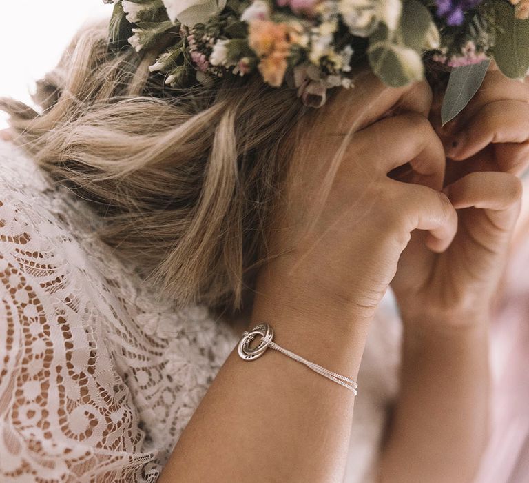 Bride in boho wedding dress wearing silver infinity knot wedding bracelet 