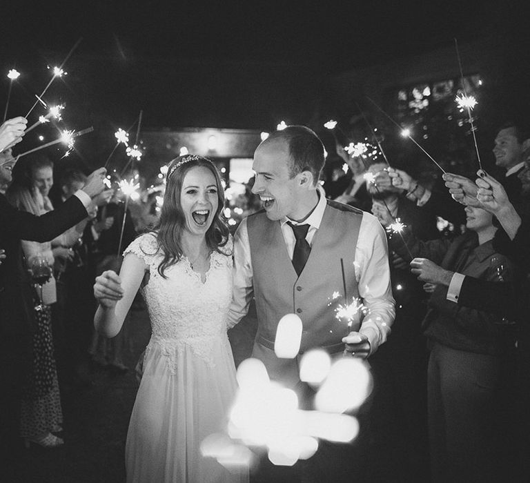 The bride and groom have a traditional sparkler send off from their Ramster Hall wedding 