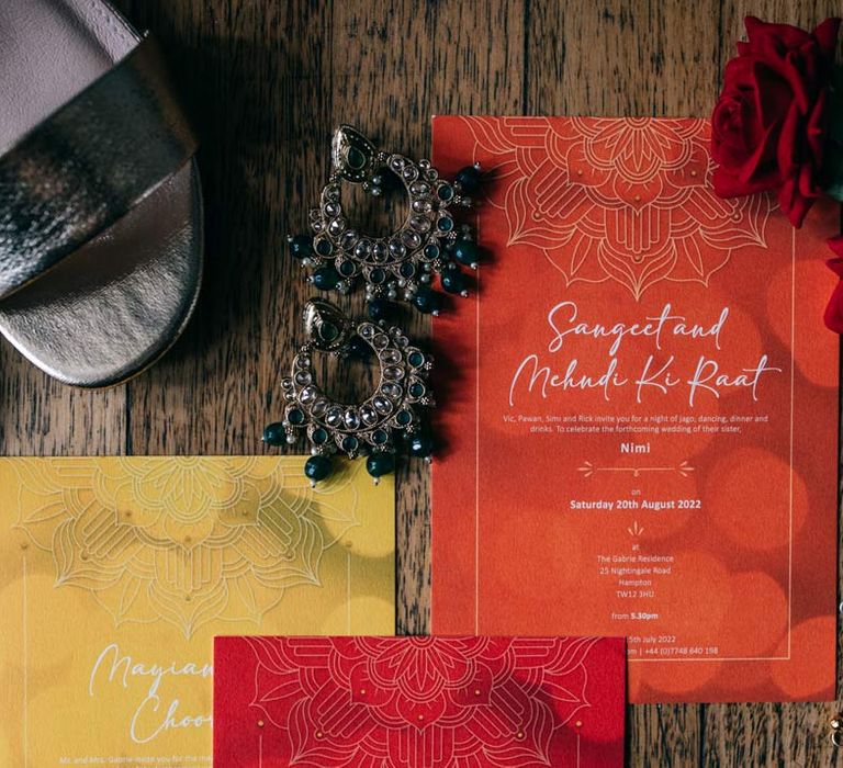 Vibrant orange, yellow and red wedding stationery with red garden roses, open toe wedding heels and gold bridal jewellery 