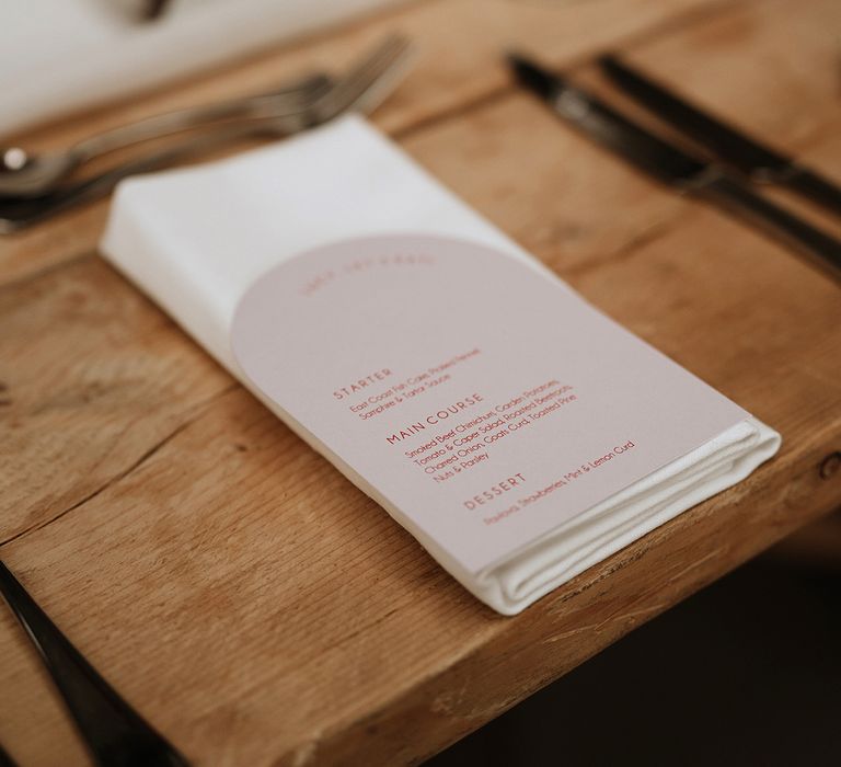 Pink and red arched wedding menu on the day stationery