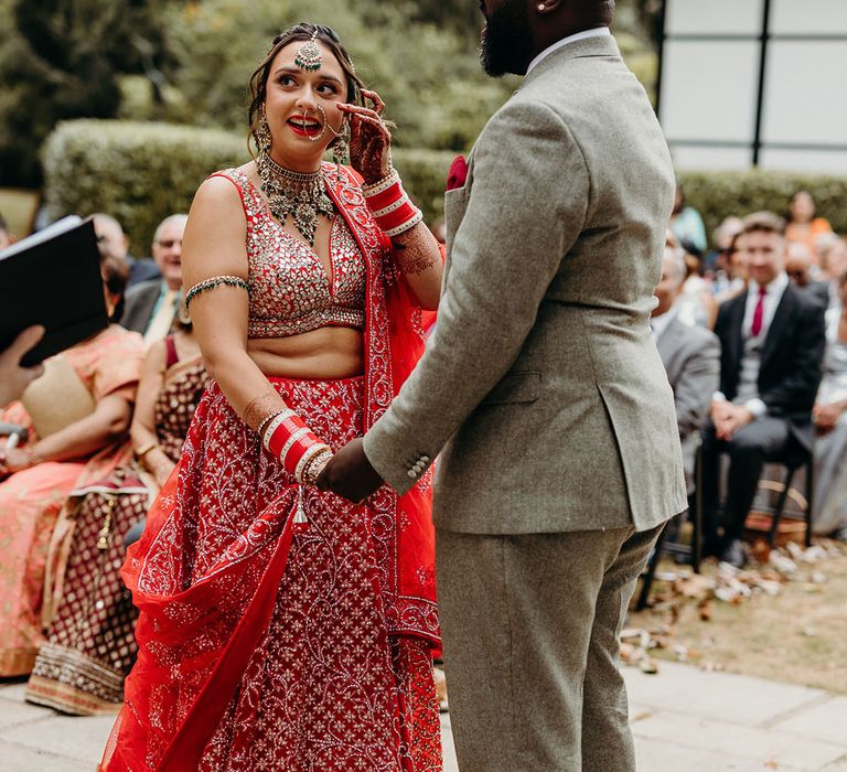 Multicultural wedding ceremony between Black groom and Indian and English bride 