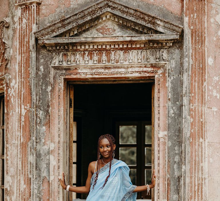 Wedding guest in powder blue wedding outfit for Larmer Tree multicultural wedding 