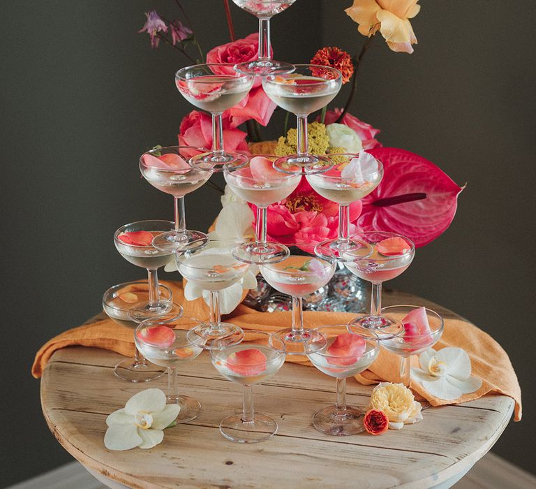 Champagne tower wedding decorations for country house wedding with rose petals 