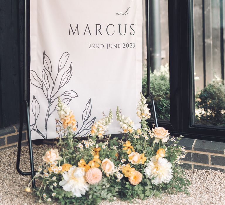 Fabric wedding welcome sign with yellow wedding flowers