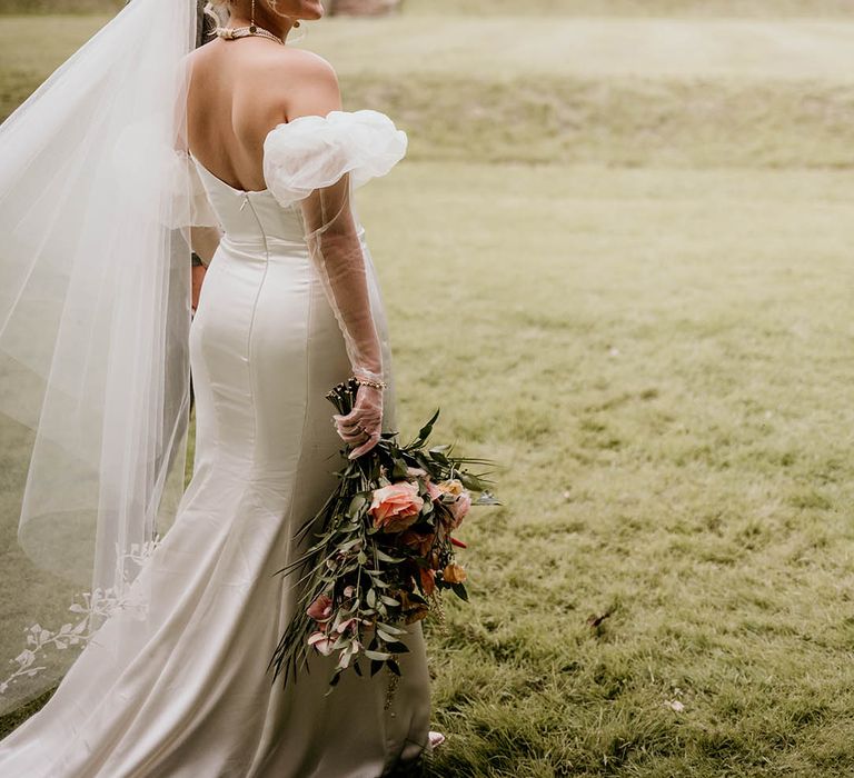 Wyresdale Park wedding with the bride and groom walking along the grounds at the venue 