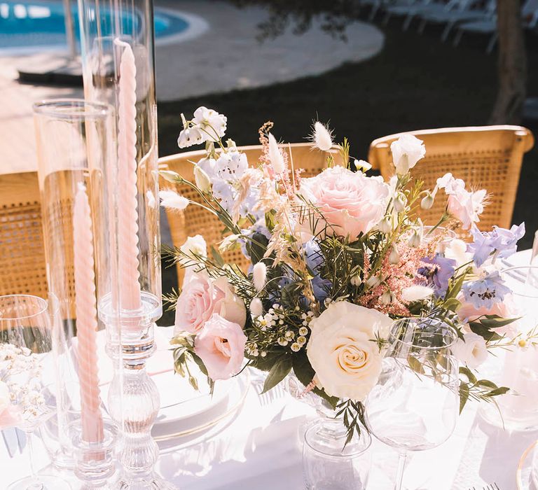 Pink wedding place setting with pink napkins and twisted candles with wedding menu stationery and boho wedding flower centrepieces 