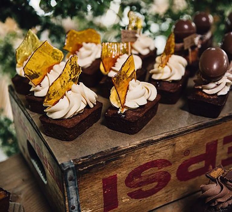 Chocolate brownies decorated with frosting including sugar glass and chocolate 