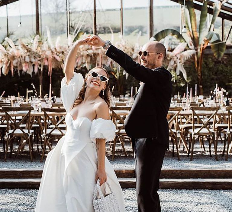 Bride and groom dancing and bride holding a pearl bridal bag by Kitty Wheeler Shaw Photography