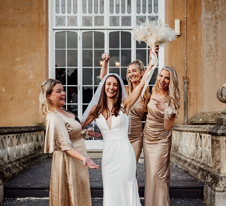 Champagne satin bridesmaid dresses for the bridal party at the mansion wedding with a champagne colour palette 