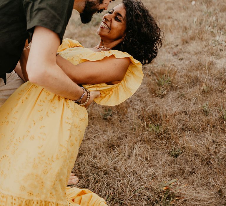 Bride in yellow dress and groom in top knot 