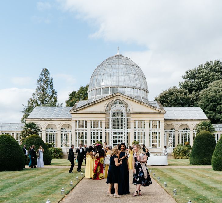 Wedding guests standing outside a Syon Park wedding 