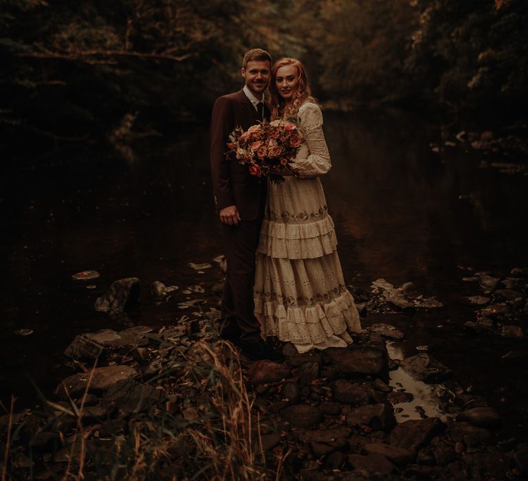 Bride in vintage wedding dress and groom in burgundy suit for Autumn inspiration 