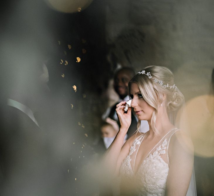 Happy bride crying at classical barn wedding