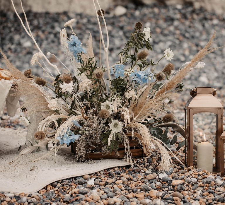 Blue and white natural floral arrangement and lanterns wedding decor 