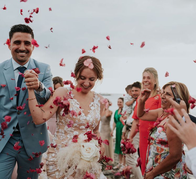 Confetti exit for bride and groom at Spanish pink and blue wedding