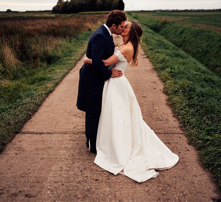 Lincolnshire countryside wedding photography with bride and groom kissing