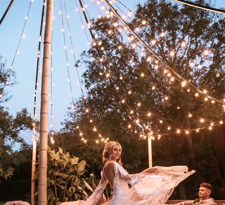 Bride showing off Rue de Seine lace wedding dress overlay details