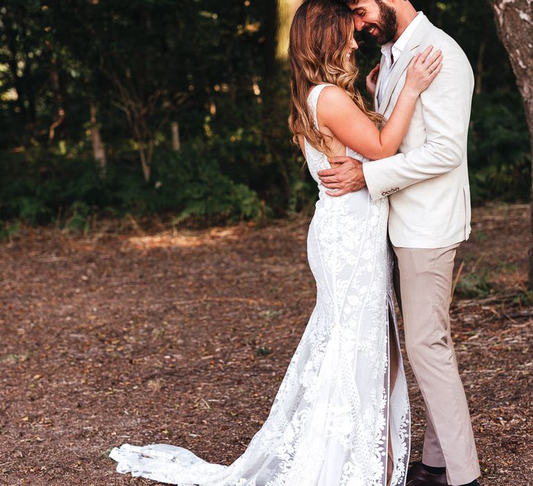 Bride & groom embrace on wedding day in boho inspiration shoot