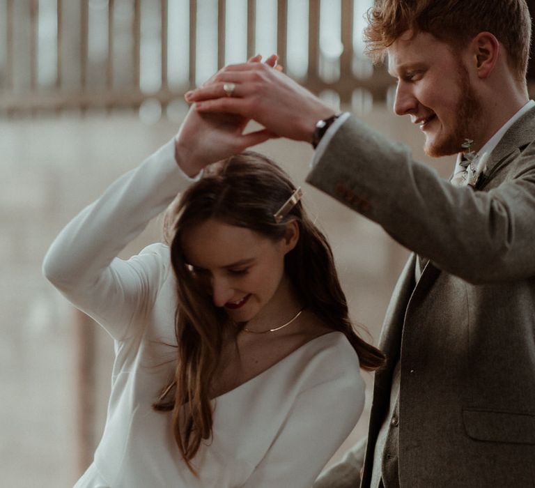 The bride and groom dancing in the barn