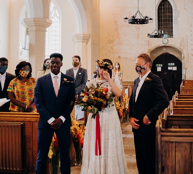 Church wedding ceremony bridal entrance with emotional bride at the altar with her father and groom 